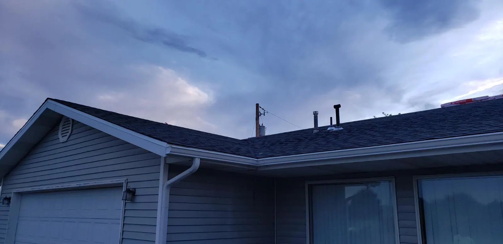 Seamless rain gutters and downspout finished along the eaves of a home in Southern Utah